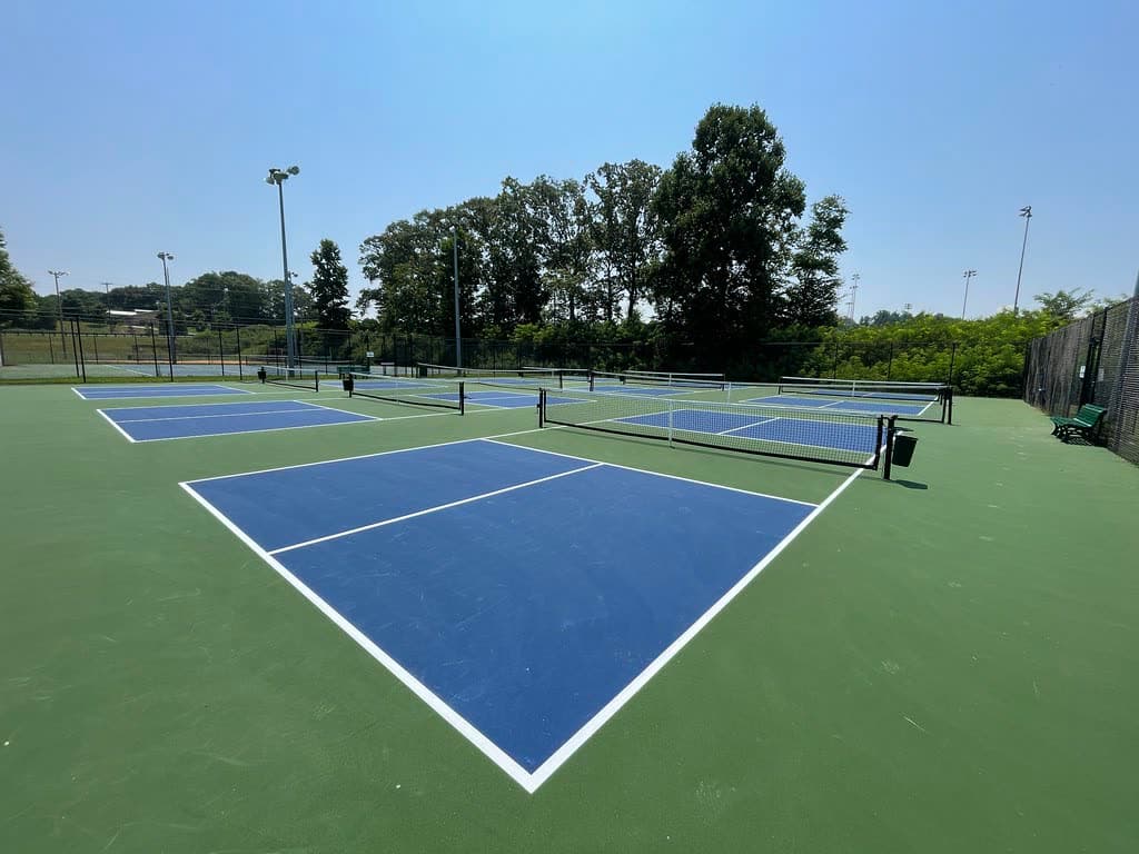 An empty pickleball court with nets